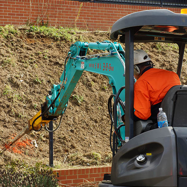 HULK Earth Anchors installed with an excavator for a new retaining wall.