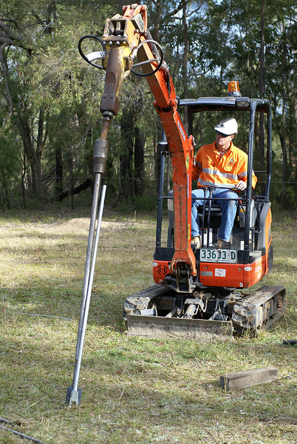 Installation demonstration of Hulk Earth Anchor, using an excavator with a mounted breaker to drive the anchor into the ground.